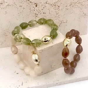 Bracelets en perles en résine ovales avec une perle centrale dorée et acier
