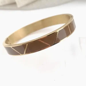 Bracelet jonc rigide large en acier doré avec motifs géométriques gravés dorés