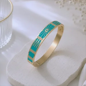 Bracelet jonc femme en acier inoxydable doré avec émail turquoise et motifs géométriques modernes.