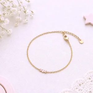 Bracelet enfant doré avec bonbon rose en acier inoxydable