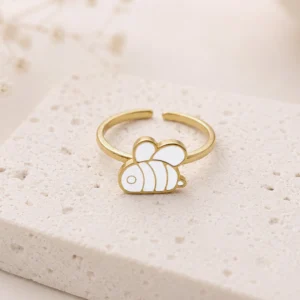 Bague enfant en acier inoxydable doré motif abeille émaillée blanche
