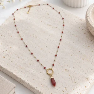 collier acier long perles rouges pendentif doré